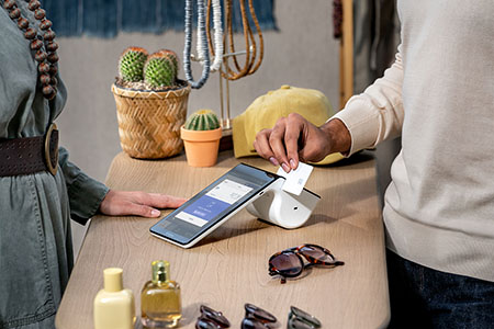 Customer swiping a card at an eyeglasses store