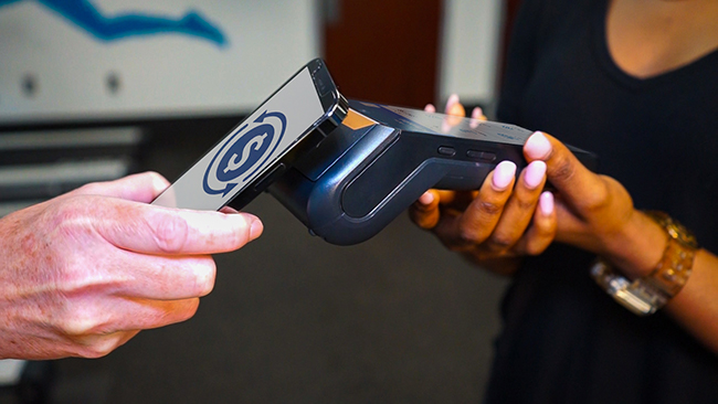 Person paying a personal trainer with their phone