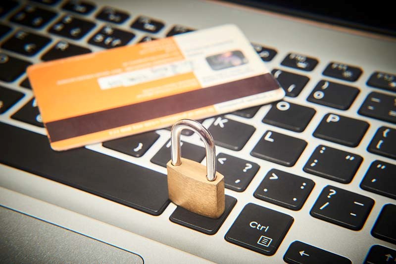 Padlock and card sitting on a keyboard